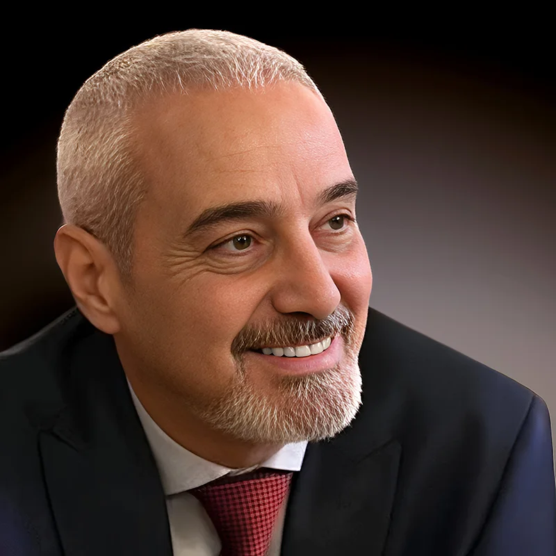 Rabih Daou smiling in a formal portrait